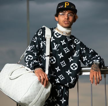 Jeune homme en tenue Louis Vuitton monogram noir et blanc avec grand sac blanc - L'Atelier du Mieux