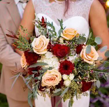 Wedding bouquet with peach and red flowers