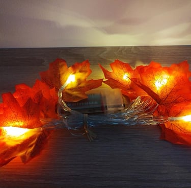 Battery-operated maple leaf string lights with 20 warm orange LEDs on a 9.8ft copper wire,