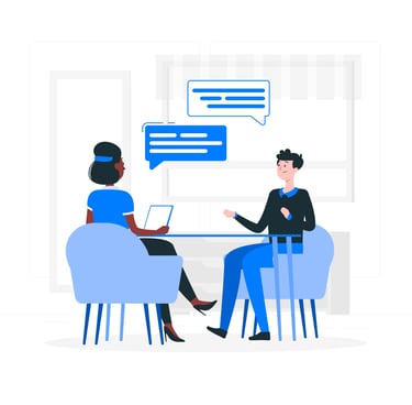 a man and woman sitting at a table with a laptop doing 1-1 consultation for resume writing