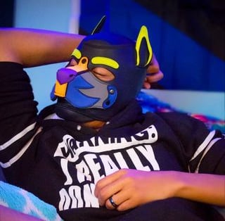 Man in a pup mask.