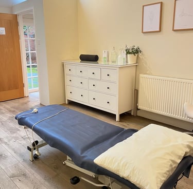 clinic room with wooden floors and patient couch