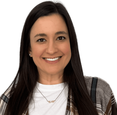 woman with long dark hair wearing a white shirt and plaid scarf