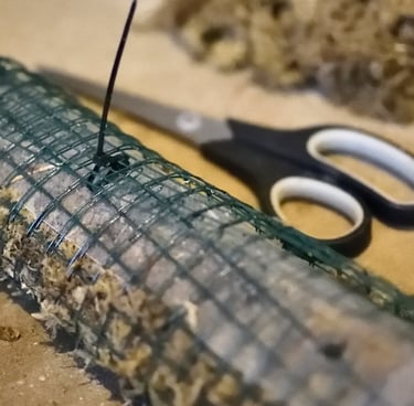 Self watering moss pole partially zipped shut with cable ties