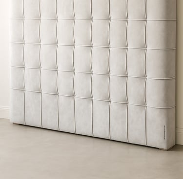 Close-up of plush grid-style upholstered wall panels showing soft texture and light shadow variation.