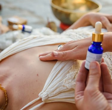 Holistic practitioner applying essential oils to a client during a spiritual sound healing session.