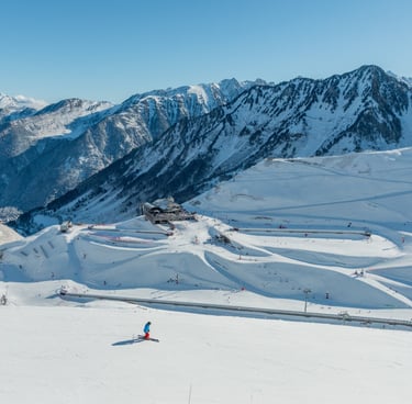 a person skiing down a mountain with a lot of snow