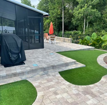 a patio with a walkway and a BBQ grill