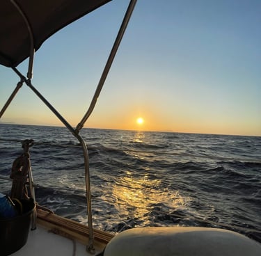 a man sitting on a boat in the ocean