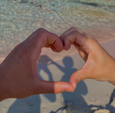 a person holding their hands in the shape of a heart