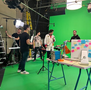 Video production crew filming on a green screen set