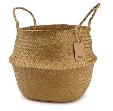 A seagrass woven storage basket with loop handles, styled upright to show its shape and texture 