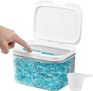 a person's hand is holding a plastic container filled with blue beads