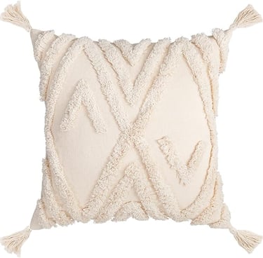 Cream boho decorative throw pillow with tufted geometric patterns and corner tassels.