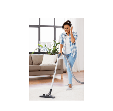 A woman vacuums while listening to an audiobook