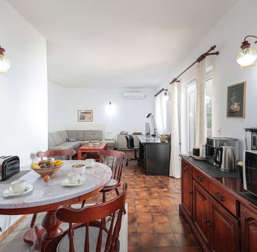 The photo shows an open-plan dining and living room.