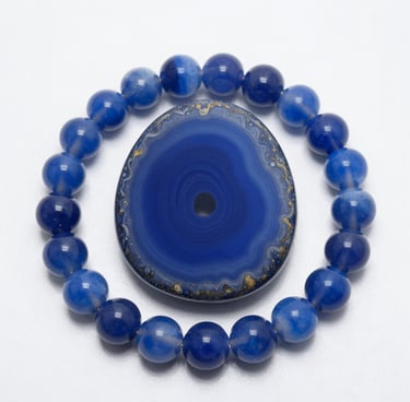 Polished moonstone crystal heart surrounded by a beaded blue lace agate gemstone bracelet.