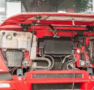 Red semi truck cab with the hood open