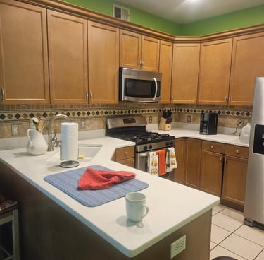 a kitchen with a table and a refrigerator