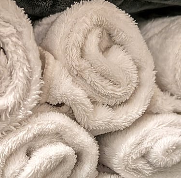 rolled white towels stacked