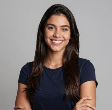 Smiling young woman showing her aligned teeth in a bright, modern orthodontic clinic.