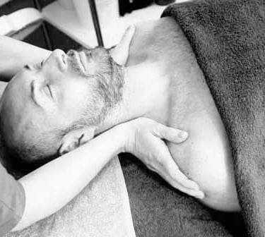 black and white image of Wollongong massage being done on shoulders