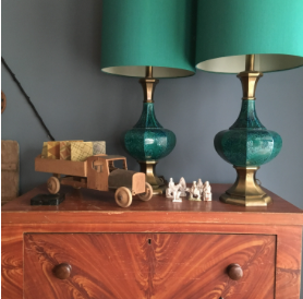 green lamp with old wood truck on an antique cabinet