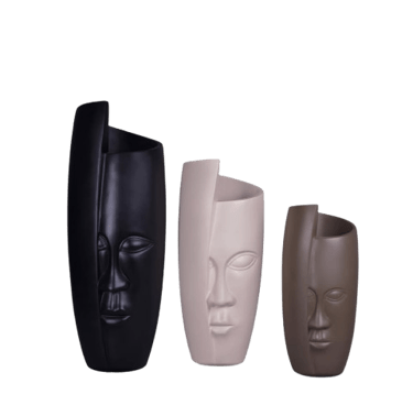 three different colored ceramic masks on a black background