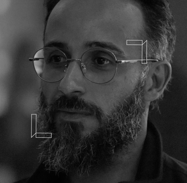 a man with a beard and glasses on his face