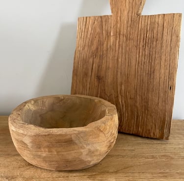 a wooden bowl with a wooden cutting board and a wooden cutting board