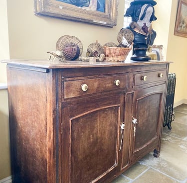 Image of a sideboard that is brown wood and could be painted