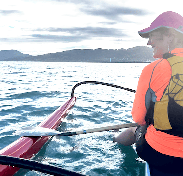 Woman in a life vest on an outrigger