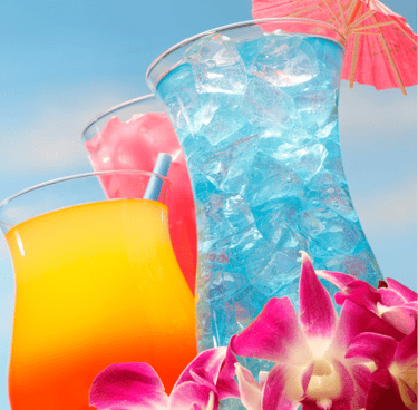 Vibrant yellow-orange and blue tropical cocktails served in glasses under a clear, bright blue sky.