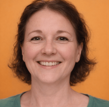 Smiling woman with short brown hair against an orange background. She wears a green shirt.