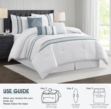 White and blue embroidered comforter set with matching decorative pillows and shams on a modern bed.