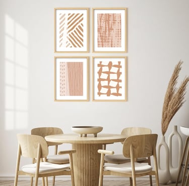 Minimalist dining room with boho abstract wall art prints and a round wooden table set.