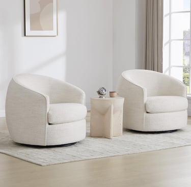 Two modern cream bouclé swivel barrel chairs arranged on a textured area rug in a minimalist living room.