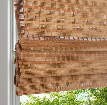 Woven natural bamboo roman shades for window privacy and light filtering in a modern home interior.