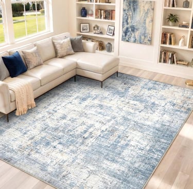 Modern blue and cream distressed area rug in a bright living room with a white sectional sofa.