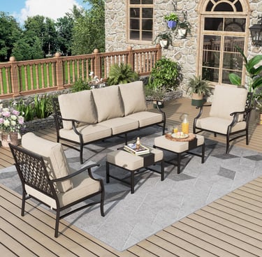 A 5-piece outdoor patio furniture set with beige cushions and black metal frames on a wooden deck.