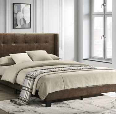 Modern brown faux leather upholstered bed frame with a button-tufted headboard in a bright bedroom.