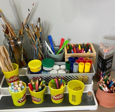 Display of art materials including crayons and paintbrushes
