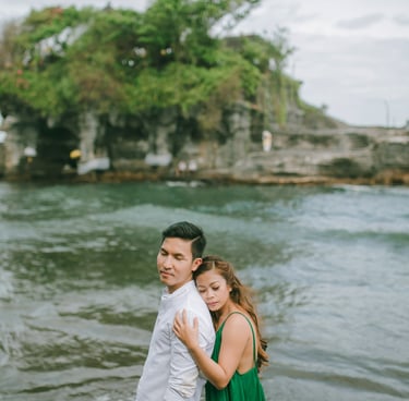 Couple portrait with Tanah Lot temple island in the background during a Bali intimate session.