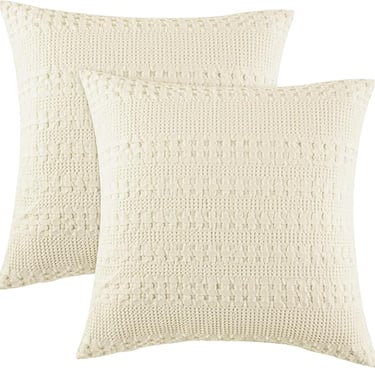 Creamy white cotton pillow covers for cozy minimalist bedroom comfort.