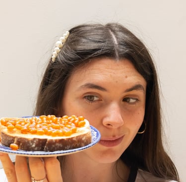 Bláithín Breathnach for Beads on Toast! Girl looking at plate of real toast covered with orange beads