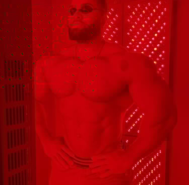 a man with a beard and eye protection on a red light therapy
