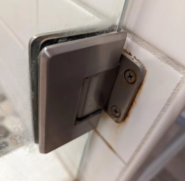 Rusty Hinge in bathroom partition