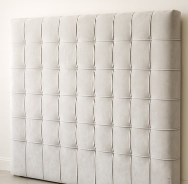 Close-up of plush grid-style upholstered wall panels showing soft texture and light shadow variation.