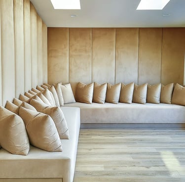 Custom wall panel bench by Solo Home Decor styled with multiple plush cushions, showing a segmented seating look