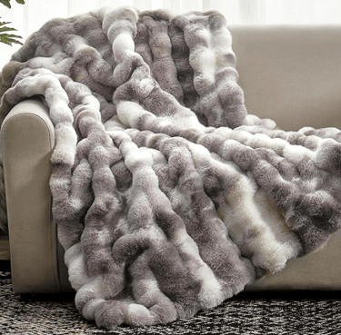 multicolored textured throw blanket (grey and white shades)